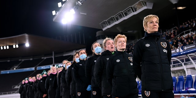 Republic of Ireland manager Vera Pauw and her backroom staff and players stand for the playing of the national anthem before the FIFA Women's World Cup 2023 qualifying Group A match between Finland and Republic of Ireland at Helsinki Olympic Stadium in Helsinki, Finland.