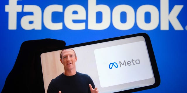 In this photo illustration, Facebook CEO Mark Zuckerberg announces Facebook's new name, Meta, in a video displayed on a smartphone screen.