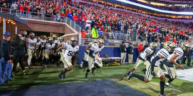 The Vanderbilt Commodores run on to the field before their game against the Ole Miss Rebels on Nov. 20, 2021, in Oxford, Mississippi.