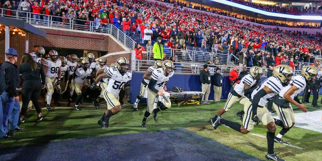 The Vanderbilt Commodores run on to the field before their game against the Ole Miss Rebels on Nov. 20, 2021, in Oxford, Mississippi.