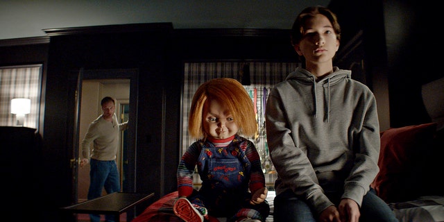 Devon Sawa, left, as Lucas Wheeler, Chucky, middle, and Teo Briones as Junior Wheeler in the Syfy series "Chucky." 