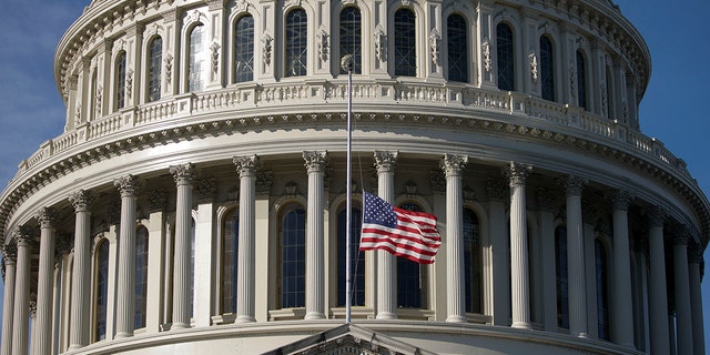 The U.S. flag flies at half-staff at the Capitol before a ceremony for the late Sen. Harry Reid on Jan. 12, 2022.
