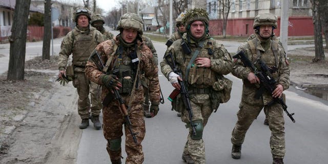 Servicemen of Ukrainian Military Forces walk in the small town of Sievierodonetsk, Lugansk Oblast, Feb. 27, 2022. 