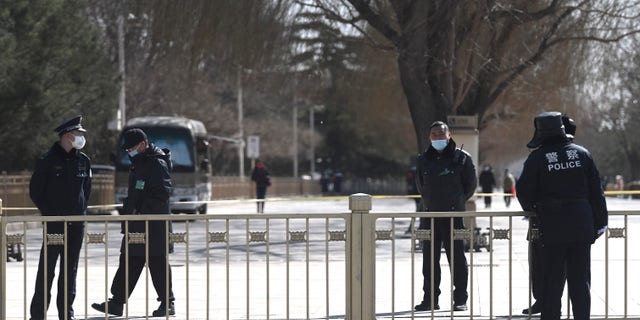Police stand guard in the Tiananmen area near the Great Hall of the People in Beijing on March 4, 2022. (Noel Celis/AFP via Getty Images)