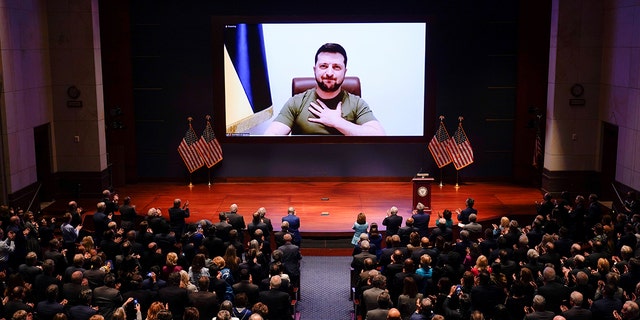 Ukrainian President Volodymyr Zelensky can be seen on screen as he delivers a video conference address to the United States Congress at the Capitol in Washington, DC, United States, March 16, 2022. (J. Scott Applewhite/Pool via Xinhua)