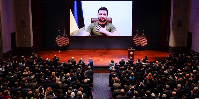 Ukrainian President Volodymyr Zelensky is showing on the screen a video conference speech to the US Parliament held at the Capitol in Washington, DC, on March 16, 2022.  (J. Scott Applewhite / Pool via Xinhua)