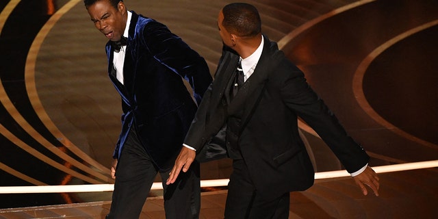 Will Smith, right, slaps Chris Rock, left, onstage during the 94th Oscars at the Dolby Theatre in Hollywood, California on March 27, 2022.