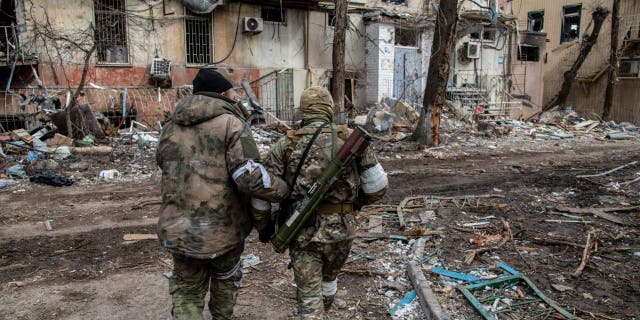 Russian and Chechen soldiers in a devastated neighborhood of Mariupol, Ukraine, near the Azovstal front line April 16, 2022. The battle between Russian/pro-Russian forces and defending Ukrainian forces led by the Azov battalion continues in the city port of Mariupol.