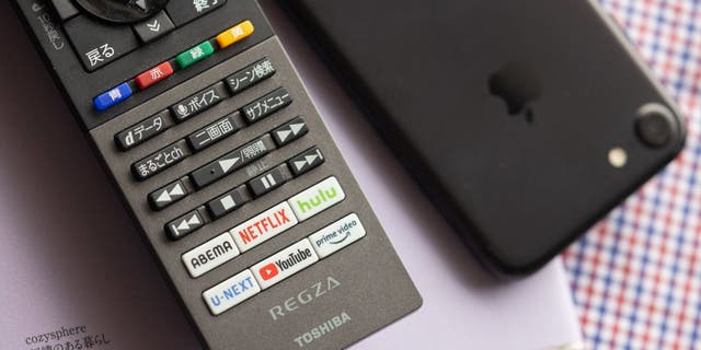 In this photo illustration, the Netflix button is on the smart TV remote control.