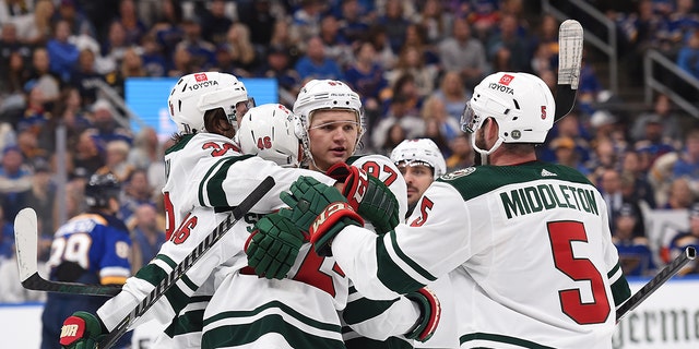 Kirill Kaprizov (97) of the Minnesota Wild is congratulated after scoring a goal against the St. Louis Blues in the first period of Game 4 of the first round of the 2022 Stanley Cup playoffs at Enterprise Center May 8, 2022, in St Louis, Mo.