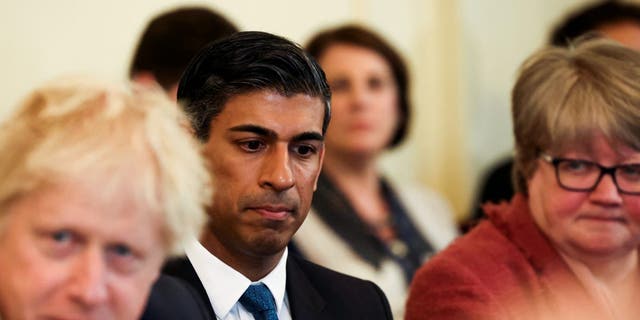 British Chancellor of the Exchequer Rishi Sunak listens (C) as Prime Minister Boris Johnson speaks at the weekly cabinet meeting in Downing Street on May 17, 2022 in London. 