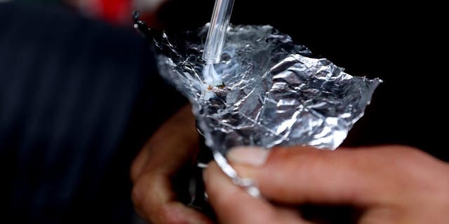 Man smoking fentanyl out of foil