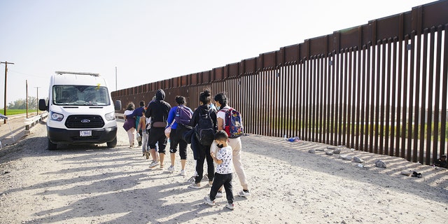 ARIZONA, USA- MAY 20: A Asylum seekers board a CBP transport van after entering the U.S.A., in Yuma Arizona., May 20, 2022 