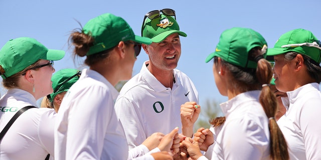 Head coach Derek Radley of the Oregon Ducks celebrates with his players after defeating the San Jose State Spartans in the quarterfinals during the Division I women's golf championship at the Grayhawk Golf Club May 24, 2022, in Scottsdale, Ariz. 