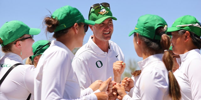 Head coach Derek Radley of the Oregon Ducks celebrates with his players after defeating the San Jose State Spartans in the quarterfinals during the Division I women's golf championship at the Grayhawk Golf Club May 24, 2022, in Scottsdale, Ariz.