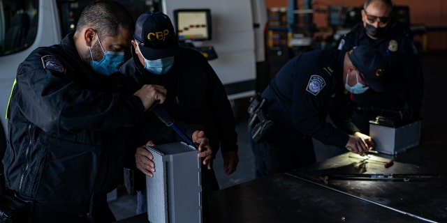 LAREDO, TEXAS - JANUARY 14: U.S. Customs and Border Protection (CBP) officers inspect a shipment of car batteries after seeing something unusual through a scanner at the Laredo Port of Entry in Laredo, Texas, Friday, January 14, 2022. 