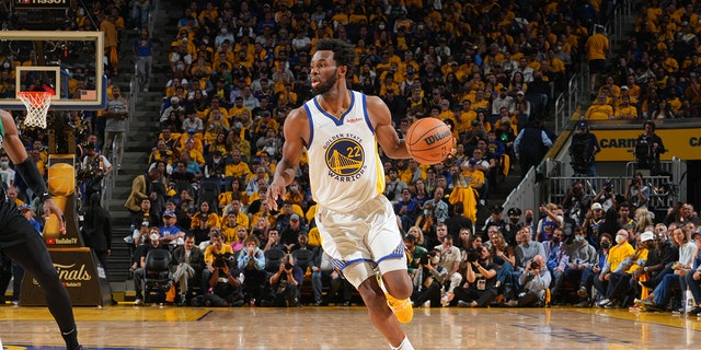 Andrew Wiggins of the Golden State Warriors dribbles the ball against the Boston Celtics during game five of the 2022 NBA Finals at the Chase Center on June 13, 2022 in San Francisco, California.