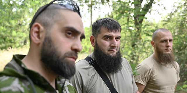 Members of the volunteer Sheikh Mansour battalion Mansour (C), Islam (L) and Asadulla (R) speak to an AFP journalist during an interview June 9, 2022, in the town of Zaporizhzhia, amid the Russian invasion of Ukraine. 