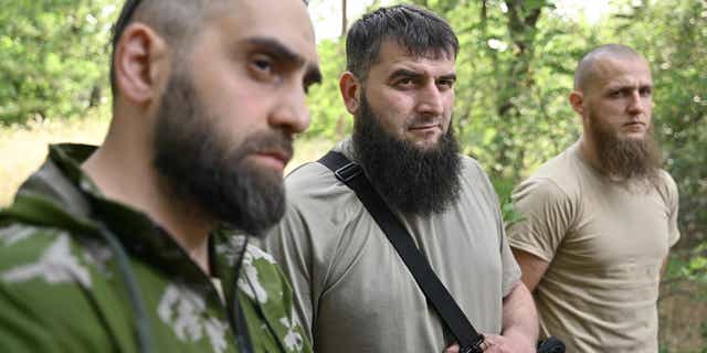 Members of the volunteer Sheikh Mansur Battalion speak to an AFP journalist during an interview on June 9, 2022, in the town of Zaporizhzhia, amid the Russian invasion of Ukraine.