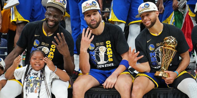 The Golden State Warriors pose for a photo with the Bill Russell NBA Finals MVP Award after Game 6 of the 2022 NBA Finals on June 16, 2022, at TD Garden in Boston, Massachusetts.