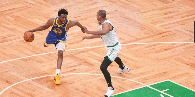 Golden State Warriors Andrew Wiggins, #22, in action, dribbles vs Boston Celtics Al Horford, #42, at TD Garden. Game 6 of the 2022 NBA Finals.