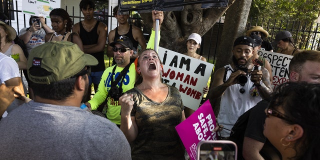 Abortion rights demonstrators and an anti-abortion demonstrator argue after a Rally For Reproductive Freedom in Austin, Texas, Sunday, June 26, 2022. The US Supreme Court overturned the 1973 Roe v.  Wade decision and wiped out the constitutional right to abortion, issuing a historic ruling likely to render the procedure largely illegal in half the country and further polarize a deeply divided nation.