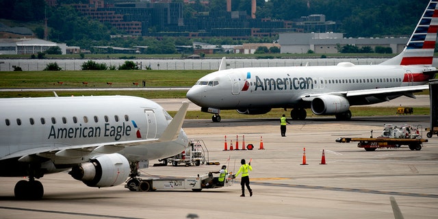 An American Eagle and American Airlines plane sit on the tarmac at Ronald Reagan Washington National Airport in Arlington, Virginia, on July 2, 2022. 