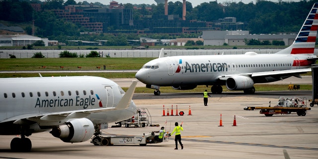 An American Eagle and American Airlines plane sit on the tarmac at Ronald Reagan Washington National Airport in Arlington, Virginia, on July 2, 2022.