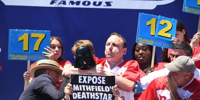 Hot dog eating champion Joey Chestnut helped subdue a protester, as a group disrupted Nathan's Famous International Hot Dog Eating Contest 2022 in Coney Island on July 4, 2022. Chestnut won his 15th title by eating 63 hot- dogs in 10 minutes.