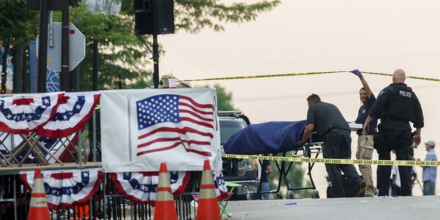 A body is transported from the scene of a mass shooting during the July 4th holiday weekend Monday, July 4, 2022, in Highland Park, Ill. (Armando L. Sanchez/Chicago Tribune/Tribune News Service via Getty Images)