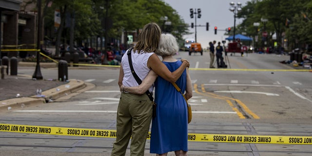 Shana Gutman and her mom Eadie Bear, lifelong residents of Highland Park, Illinois, take a look at the Central Avenue scene Tuesday, July 5, 2022, the day after a mass shooting at the Fourth of July parade.