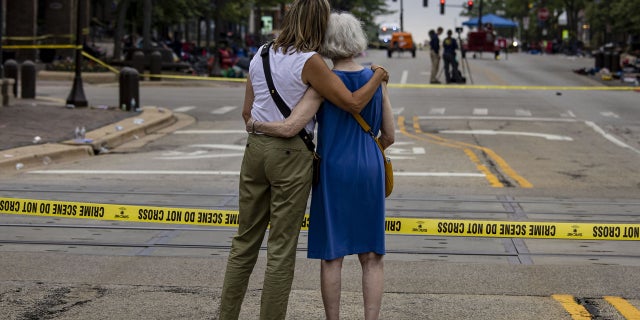 Shana Gutman and her mom Eadie Bear, lifelong residents of Highland Park, Illinois, take a look at the Central Avenue scene Tuesday, July 5, 2022, the day after a mass shooting at the Fourth of July parade.