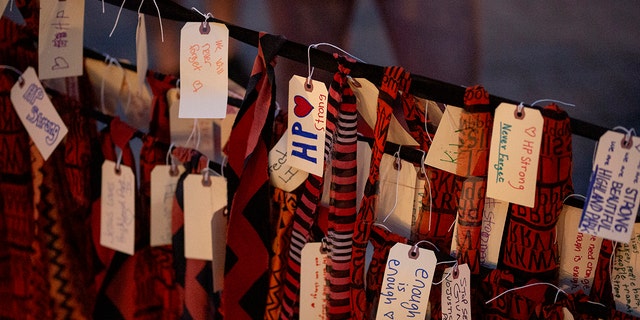 People add strips of cloth with names and phrases memorializing the victims at a vigil near the scene of a mass shooting yesterday at a Fourth of July parade, on July 5, 2022 in Highland Park, Illinois.