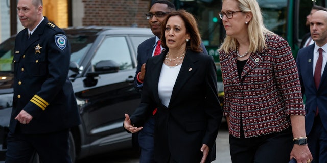 US Vice President Kamala Harris (C) walks next to Highland Park Mayor Nancy Rotering (R) as she makes a surprise visit to the site of a shooting that left seven people dead in Highland Park, Illinois, on July 5, 2022. (Photo by KAMIL KRZACZYNSKI / AFP) (Photo by KAMIL KRZACZYNSKI/AFP via Getty Images)