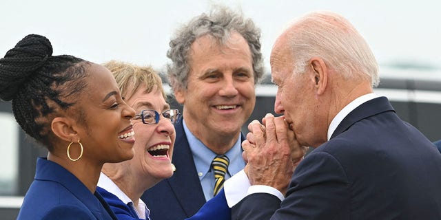 US President Joe Biden is greeted by (L-R) US Representatives Shontel Brown and Marcy Kaptur, US Senator Sherrod Brown and Cleveland Mayor Justin Bibb