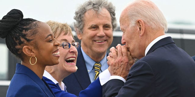 US President Joe Biden is greeted by (L-R) US Representatives Shontel Brown and Marcy Kaptur, US Senator Sherrod Brown