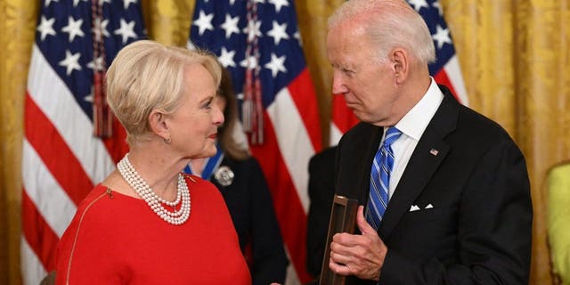 US President Joe Biden presents Cindy McCain, the widow of former Senator and presidential candidate John McCain, posthumously with the Presidential Medal of Freedom, the nation's highest civilian honor, during a ceremony honoring 17 recipients, in the East Room of the White House in Washington, DC, July 7, 2022. 