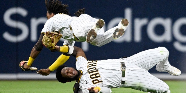 C.J. Abrams, #77 of the San Diego Padres, (R) collides with Jurickson Profar, #10, as he makes a catch on a ball hit by Tommy La Stella, #8 of the San Francisco Giants, during the fifth inning of a baseball game July 7, 2022 at Petco Park in San Diego, California. Profar was injured on the play.