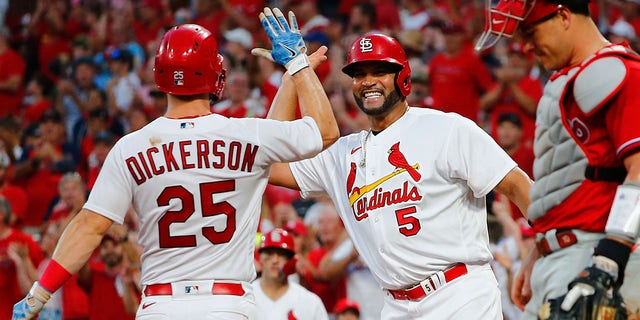 Albert Pujols #5 of the St. Louis Cardinals celebrates with Corey Dickerson #25 of the St. Louis Cardinals after Dickerson hit a two-run home run against the Philadelphia Phillies in the seventh inning at Busch Stadium on July 11, 2022 in St Louis, Missouri. 