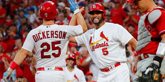 Albert Pujols #5 of the St. Louis Cardinals celebrates with Corey Dickerson #25 of the St. Louis Cardinals after Dickerson hit a two-run home run against the Philadelphia Phillies in the seventh inning at Busch Stadium on July 11, 2022 in St Louis, Missouri.