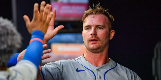 New York first baseman Pete Alonso (20) won a high five in a dugout during the New York Mets-Atlanta Braves MLB match on July 11, 2022 at Troisto Park, Atlanta, Georgia.