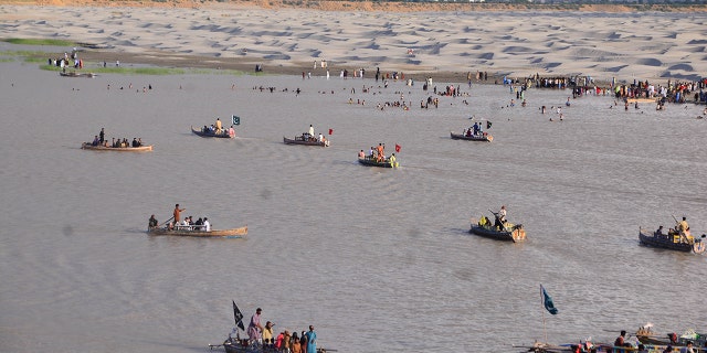 Hyderabad, Pakistan-July 12: Pakistan people on the banks of Pakistan's largest Indus River in Hyderabad, southern Sindh, Pakistan, July 12, 2022.