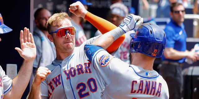 Mark Canha #19 reacts with Pete Alonso #20 of the New York Mets after his home run during the sixth inning against the Atlanta Braves at Truist Park on July 13, 2022, in Atlanta, Georgia.
