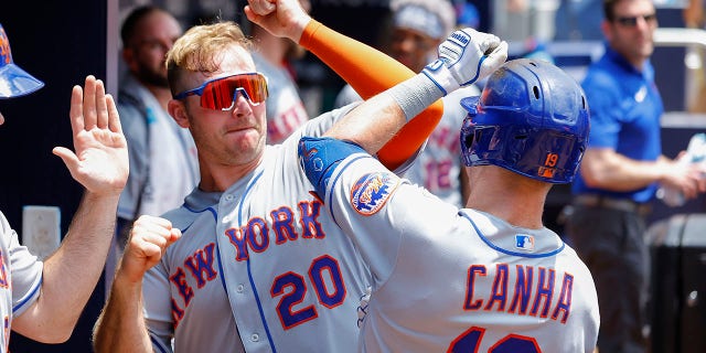 Mark Canha #19 reacts with Pete Alonso #20 of the New York Mets after his home run during the sixth inning against the Atlanta Braves at Truist Park on July 13, 2022, in Atlanta, Georgia.