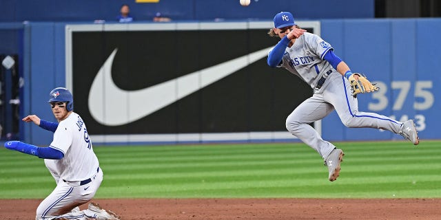 Kansas City Royals Short Stop Bobby Witt Jr (7) attempts to complete a double play in the fifth inning as Toronto Blue Jays Catcher Danny Jansen (9) slides into second base during the regular season MLB game between the Kansas City Royals and Toronto Blue Jays on July 14, 2022 at Rogers Centre in Toronto, ON.