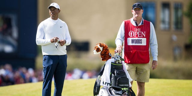 Tiger Woods and caddie Joe LaCava on the 18th tee during The 150th Open at St. Andrews Old Course July 15, 2022, in St. Andrews, Scotland. 