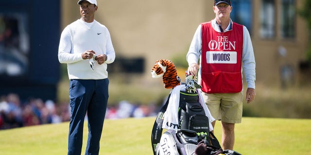 Tiger Woods and caddie Joe LaCava on the 18th tee during The 150th Open at St. Andrews Old Course July 15, 2022, in St. Andrews, Scotland.
