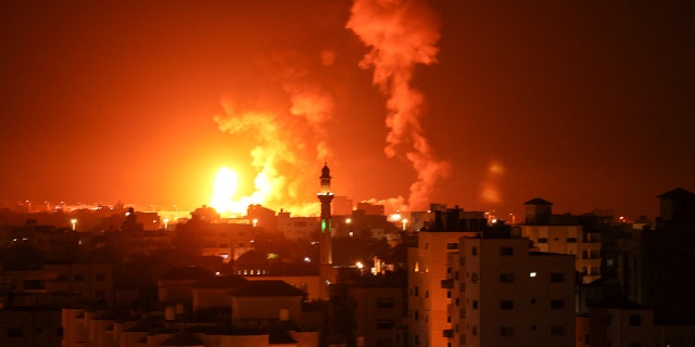 Fires are seen after an Israeli airstrike on Gaza City on July 16, 2022. - Israeli warplanes attacked a weapons factory in the Gaza Strip in the early hours of July 16, the military said, following a rocket attack on Israeli territory. (Photo by Mahmoud HAMSA/AFP)