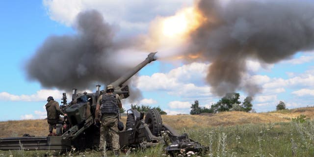 Ukrainian servicemen fire a towed howitzer in eastern Ukraine. This photo cannot be distributed in the Russian Federation. 