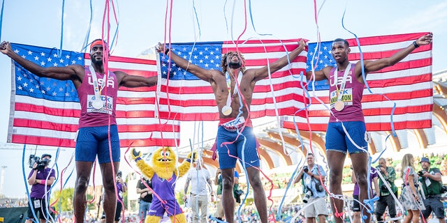 Arianne Knighton (R), bronze winner, Noah Lyles (M), gold winner, and Kenneth Bednarek, silver medalist, cheer after a race from the United States on July 21, 2022 in Eugene, Oregon. 